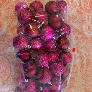 Approximately 35-40 pink plastic Christmas balls.